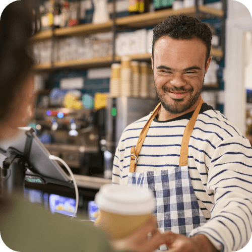 person with a disbaility serving coffee at a coffee shop