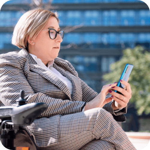 professional female person with disability outside looking at her phone